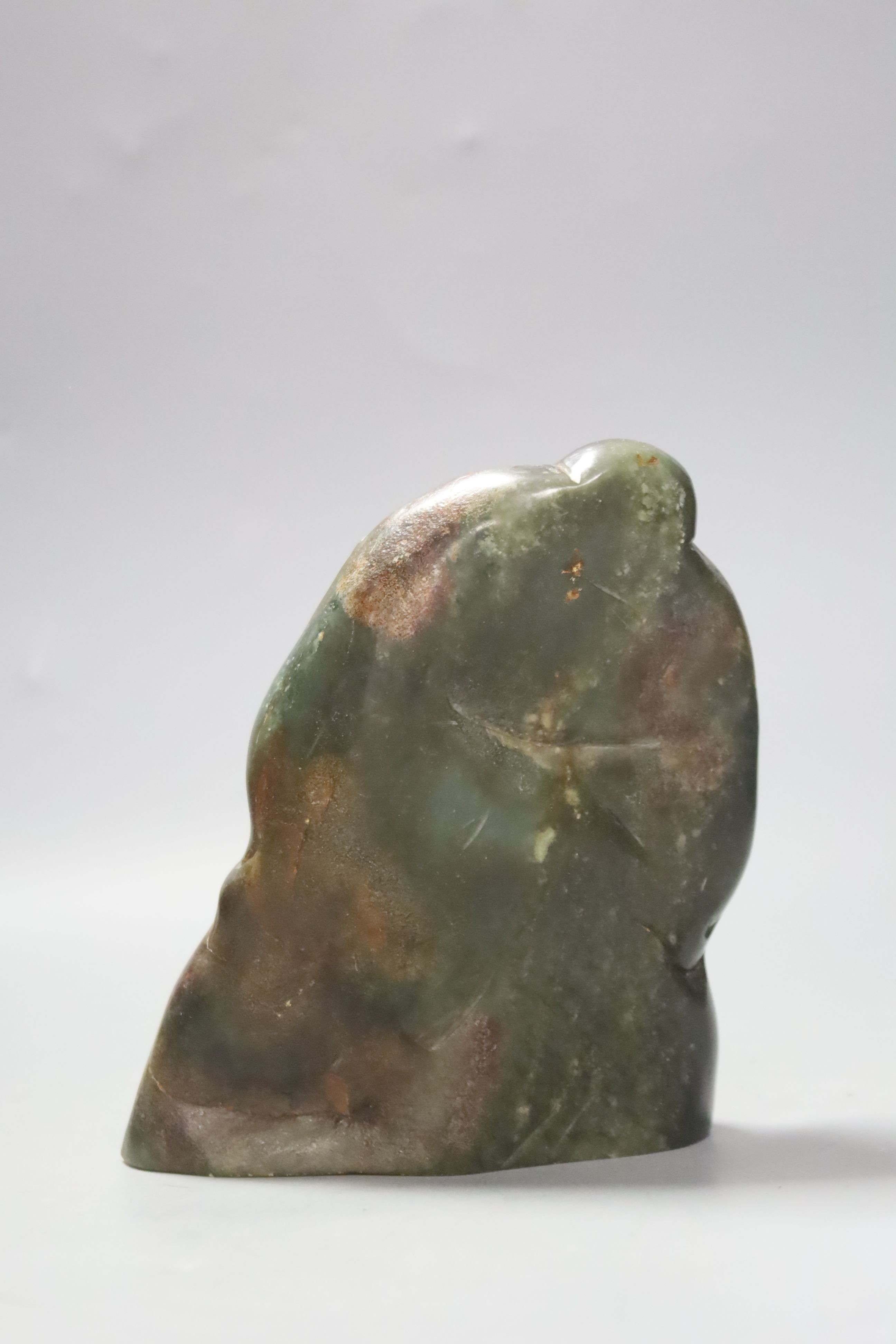 A Mongolian or Chinese green and brown jade figure of a general, 15cm high